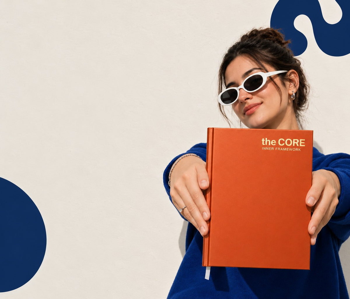 Woman holding an orange Core Series A4 hardbound notebook
